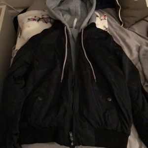 Black bomber jacket with grey zip up hoodie